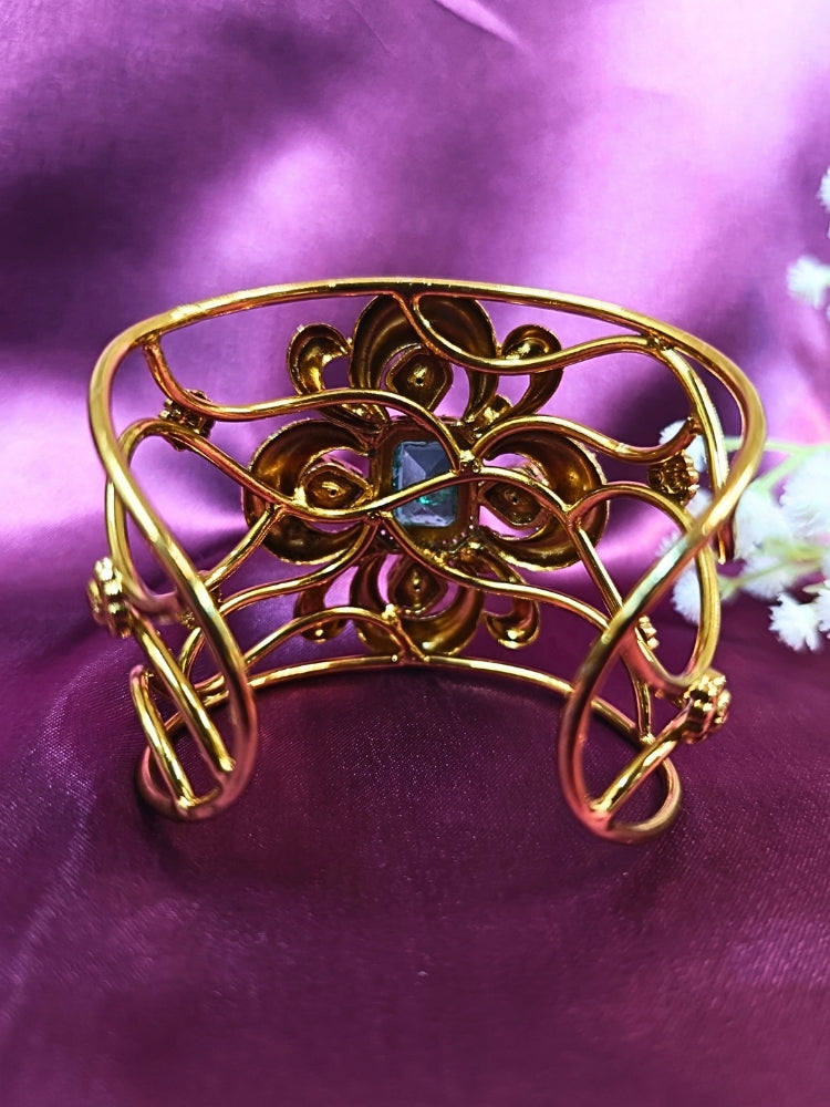 The Aziza Mint Green Bracelet (Adjustable) showcases an intricate floral design with a large Mint Green center stone, kundan and smaller Mint Green colored stones, set against a rich purple background—an ideal choice for wedding jewelry.