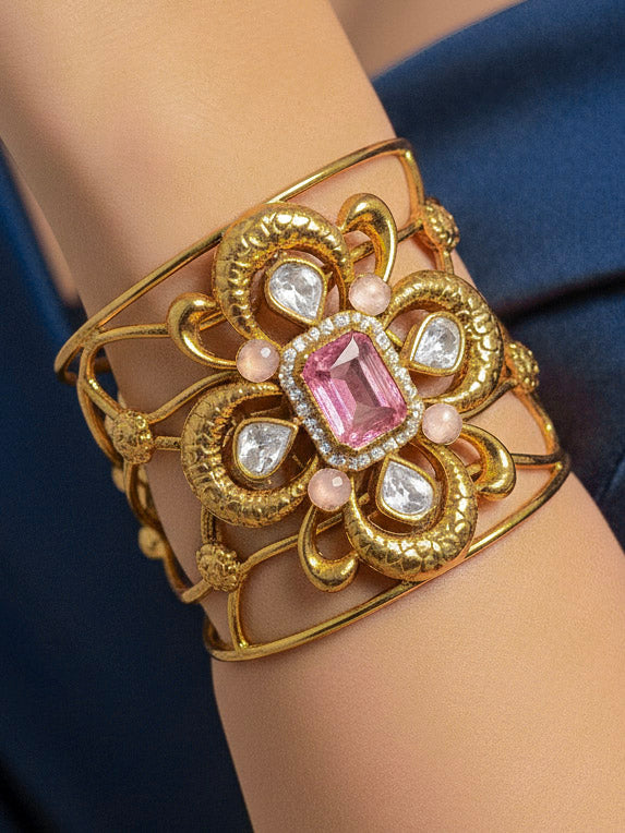 Close-up of a woman wearing an ornate traditional (Gold Polish) Mint Pink Bracelet with  American Diamonds and Colored Stones. Festive Diwali outfit paired with a colorful Colored Stone Bracelet. Wedding function styling with a premium Colored Stone imitation Bracelet.