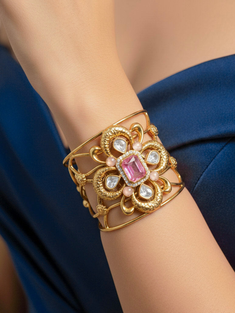 Close-up of a woman wearing an ornate traditional (Gold Polish) Mint Pink Bracelet with  American Diamonds and Colored Stones. Festive Diwali outfit paired with a colorful Colored Stone Bracelet. Wedding function styling with a premium Colored Stone imitation Bracelet.