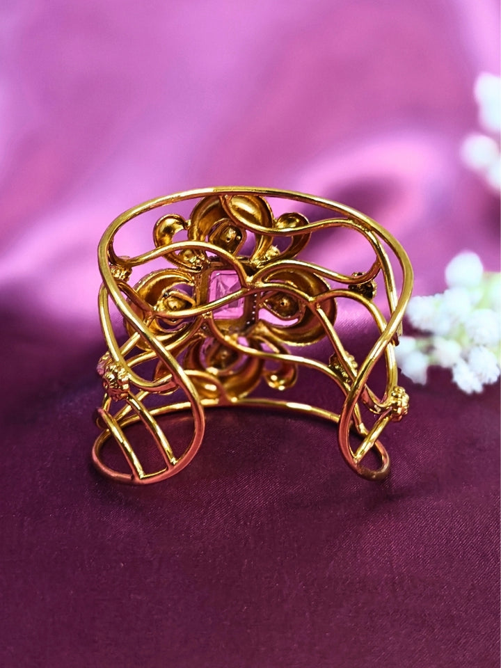 The Aziza Mint Pink Bracelet (Adjustable) showcases an intricate floral design with a large Mint Pink center stone, kundan and smaller Mint Pink colored stones, set against a rich purple background—an ideal choice for wedding jewelry.