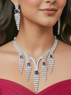 "A close-up shot of a bride wearing a stunning artificial diamond necklace with Purple colored stone and matching earrings and matching maangtikka, designed to complement bridal attire. This affordable diamond necklace set is perfect for brides seeking luxurious but cost-effective wedding jewelry in India."