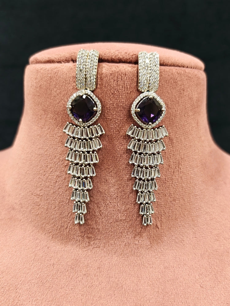 Close-up of an ornate Western Silver Diamond Collar jewellery set, earrings and Mangtikka with American Diamond and Purple Color Stone. Close-up of a Wedding, Reception look featuring a premium American diamond necklace.