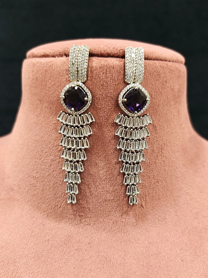 Close-up of an ornate Western Silver Diamond Collar jewellery set, earrings and Mangtikka with American Diamond and Purple Color Stone. Close-up of a Wedding, Reception look featuring a premium American diamond necklace.