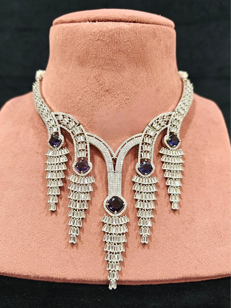 Close-up of an ornate Western Silver Diamond Collar jewellery set, earrings and Mangtikka with American Diamond and Purple Color Stone. Close-up of a Wedding, Reception look featuring a premium American diamond necklace.