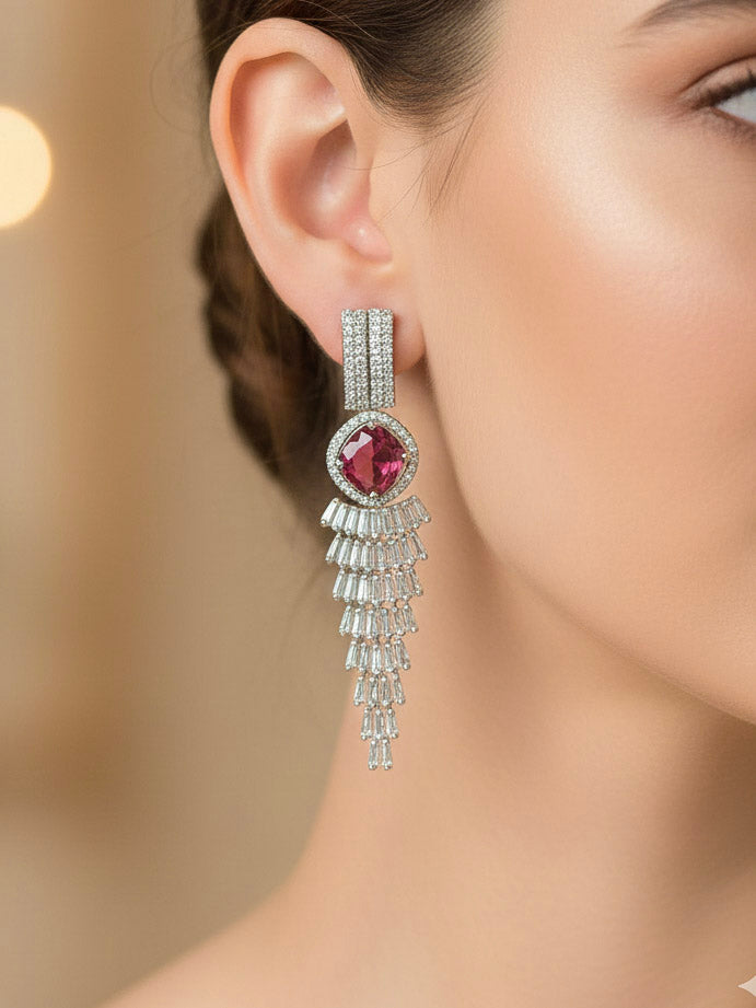 "A stunning woman wearing a glamorous  necklace with red colored stone paired with chic earrings and maangtikka, perfect for bridal wear. This high-quality artificial diamond jewelry set is the ideal choice for modern brides looking for a budget-friendly option with timeless sparkle."