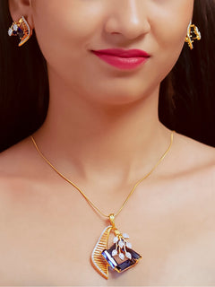 Close-up of a woman wearing an ornate Western Blue (gold Polish) Colored Stones  Pendant set and earrings with American Diamond and Colored Stones. Elegant festive look with a high-quality imitation American diamond Pendant set. Indo-western outfit styled with a statement American diamond Pendant set.