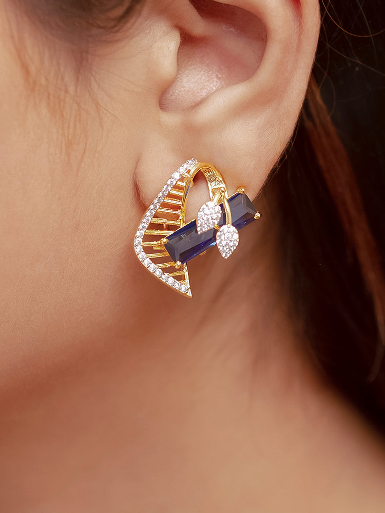 Close-up of a woman wearing an ornate Western Blue (gold Polish) Colored Stones  Pendant set and earrings with American Diamond and Colored Stones. Elegant festive look with a high-quality imitation American diamond Pendant set. Indo-western outfit styled with a statement American diamond Pendant set.