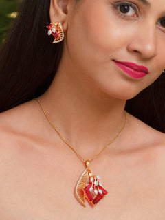 Close-up of a woman wearing an ornate Western Red (gold Polish) Colored Stones  Pendant set and earrings with American Diamond and Colored Stones. Elegant festive look with a high-quality imitation American diamond Pendant set. Indo-western outfit styled with a statement American diamond Pendant set.