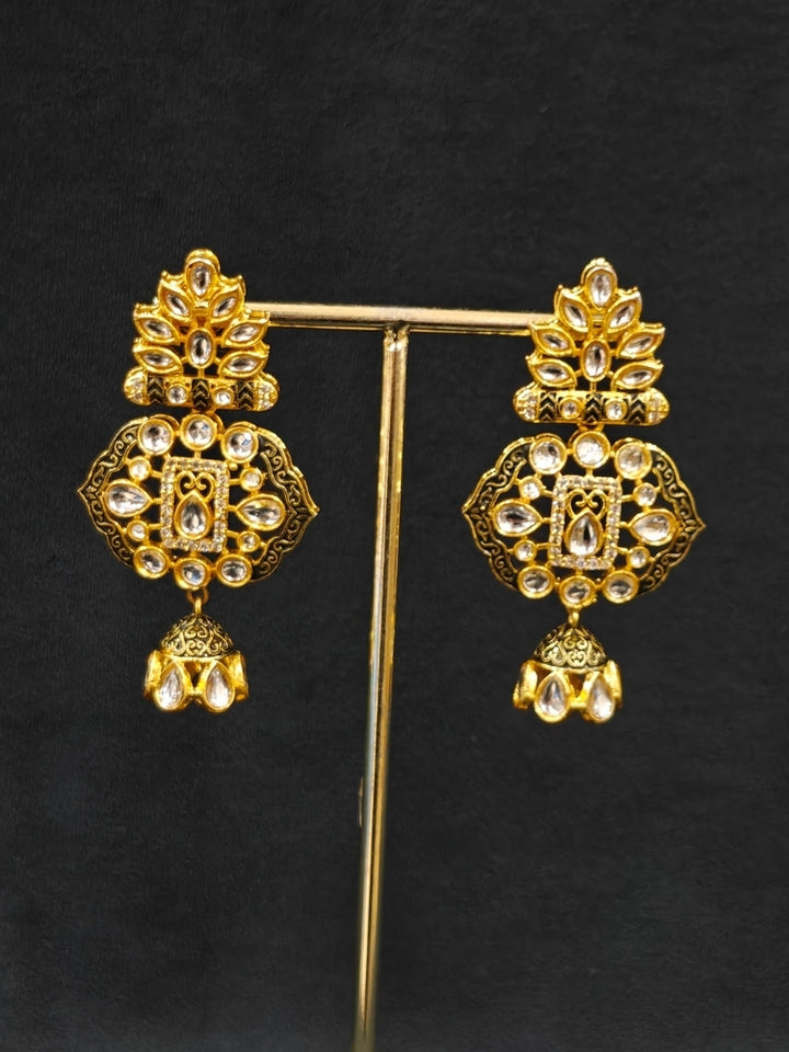 Close-up of an ornate traditional Black Meenakari gold Long jewellery set and earrings with Kundan, Meenakari work, crystal beads, pearls and American Diamonds. Wedding function styling with a premium Meenakari imitation necklace. Close-up of enamel work in Meenakari artificial wedding jewelry.