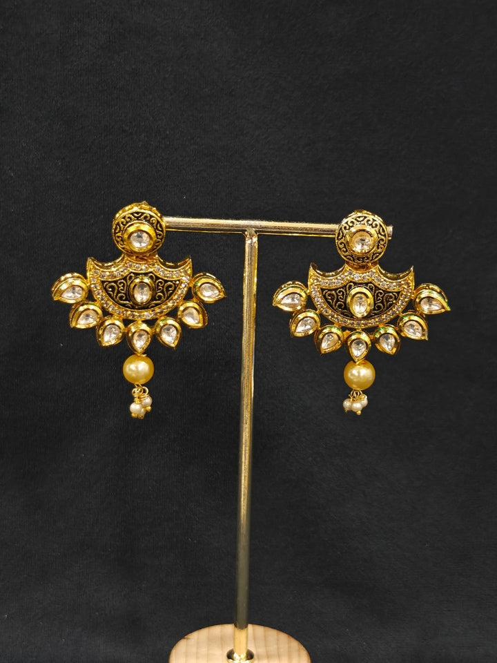 Close-up of an ornate traditional Black Meenakari Long  jewellery set and earrings with Kundan, Meenakari work, crystal beads, pearls and American Diamond. Mehendi ceremony look completed with a Meenakari jewelry set. A vibrant Meenakari artificial jewelry set for celebrations.