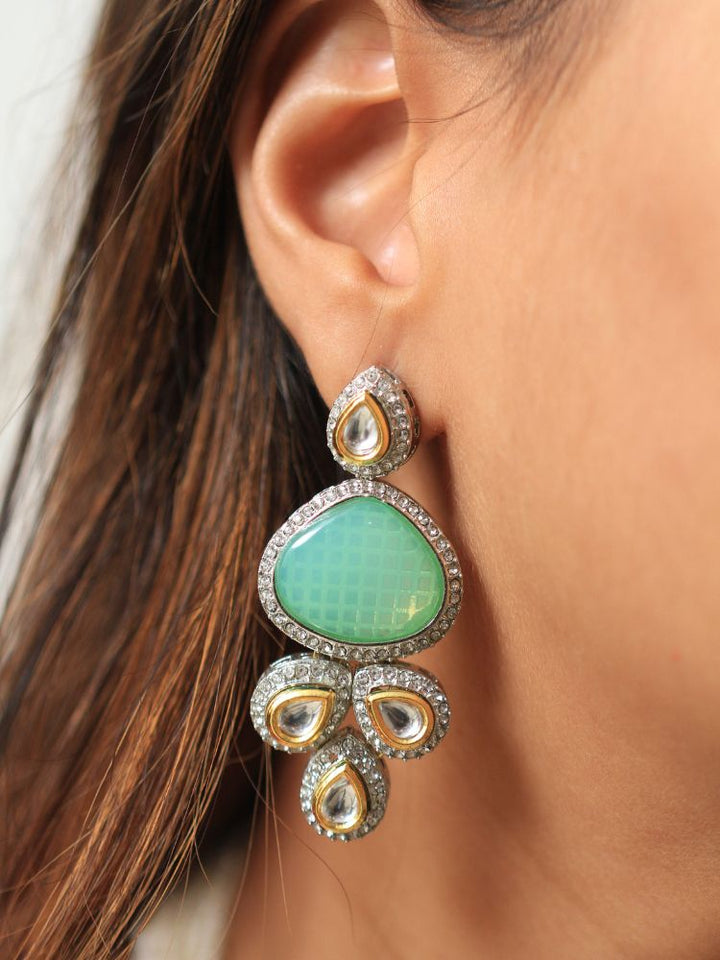 A woman in a  Red outfit smiles, showcasing the Peacoski Blue Tamanna Necklace Set and matching earrings. Her soft makeup highlights the elegance of this statement jewelry ensemble.