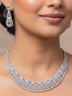 Close-up of a woman wearing an ornate Western Lilac (Silver Polish) Collar Diamond jewellery set and earrings with American Diamond and Lilac Colored Stones. Model wearing a lightweight American diamond necklace perfect for long wedding functions. 