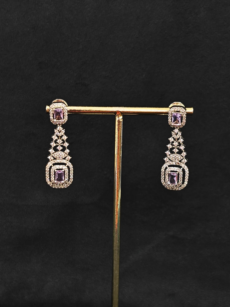 Close-up of an ornate Western Lilac (Silver Polish) Collar Diamond jewellery set and earrings with American Diamond and Lilac Colored Stones. A lightweight American diamond necklace perfect for long wedding functions. 