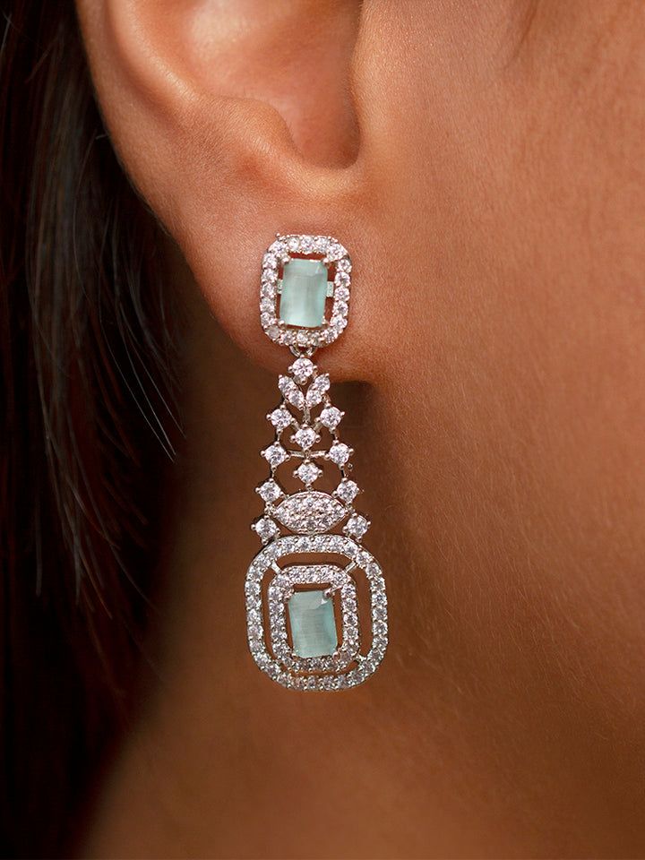 A woman showcasing a beautiful artificial diamond necklace with mint green colored stone and earrings set, ideal for festivals, family gatherings, and special celebrations in India. This elegant diamond jewelry provides the perfect blend of sparkle and tradition, with a modern twist.