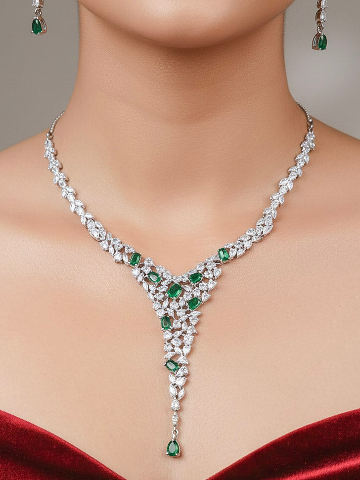 A close-up shot of a bride wearing a stunning artificial diamond necklace with green colored stone and matching earrings, designed to complement bridal attire. This affordable diamond necklace set is perfect for brides seeking luxurious but cost-effective wedding jewelry in India.