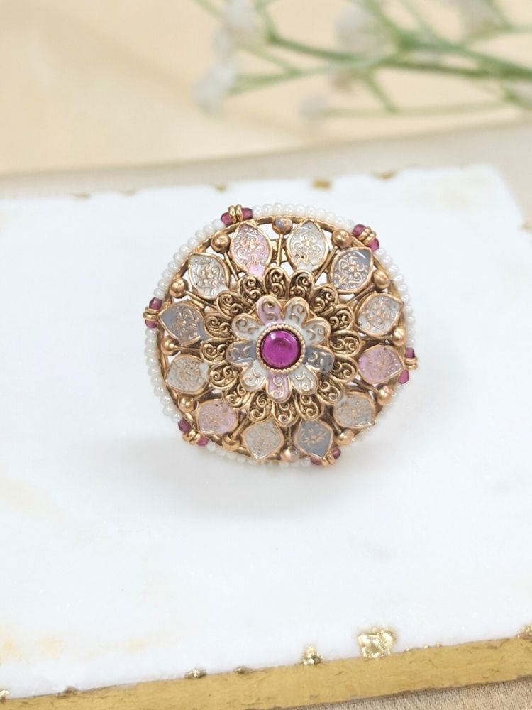Close-up of an ornate traditional Multi-Color Meenakari gold Ring with Pearls, Colored Stone and Meenakari. A trendy artificial Meenakari ring for wedding season in India. Close-up of a high-quality imitation Meenakari ring with intricate detailing.