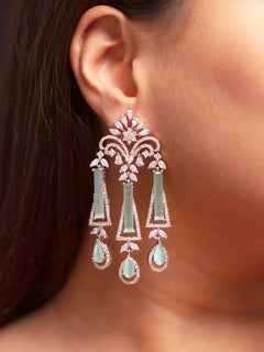Close-up of a woman wearing an ornate Western Mint Green (Silver Polish) Diamond Earrings with American Diamond and Colored Stones. Close-up of American diamond earrings styled for a reception party. Cocktail party outfit paired with sparkling artificial American Diamond earrings.