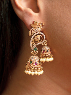 Close-up of a woman wearing an ornate traditional (gold Polish) Diamond Earrings with American Diamond, colored Stones and Pearls. Saree styling inspiration featuring elegant imitation American Diamond earrings. Woman wearing trendy artificial earrings for a 2026 wedding celebration in India.