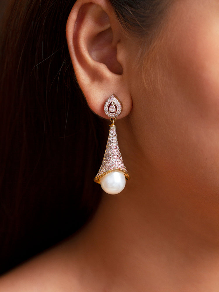 Close-up of a woman wearing an ornate Western (Silver Polish) White Diamond Earrings with American Diamonds and Pearls. Cocktail party outfit paired with sparkling artificial American Diamond earrings. Wedding guest outfit enhanced with American diamond drop earrings.