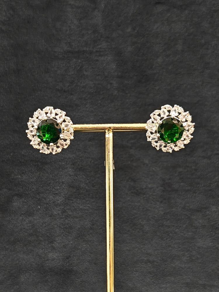 Close-up of an ornate Western American Diamond layered Silver jewellery set, Earrings and Ring with American Diamond and Green Colored Stones. Party wear outfit completed with a lightweight American diamond necklace. Close-up of a cocktail party look featuring a premium American diamond necklace.