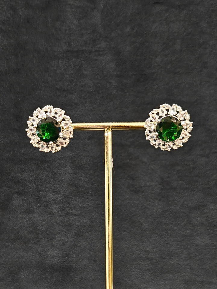 Close-up of an ornate Western American Diamond layered Silver jewellery set, Earrings and Ring with American Diamond and Green Colored Stones. Party wear outfit completed with a lightweight American diamond necklace. Close-up of a cocktail party look featuring a premium American diamond necklace.
