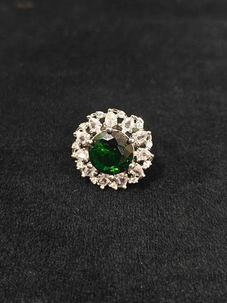 Close-up of an ornate Western American Diamond layered Silver jewellery set, Earrings and Ring with American Diamond and Green Colored Stones. Party wear outfit completed with a lightweight American diamond necklace. Close-up of a cocktail party look featuring a premium American diamond necklace.