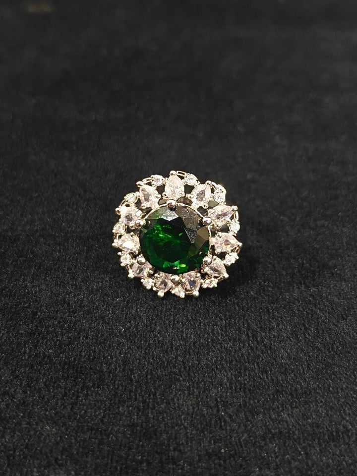 Close-up of an ornate Western American Diamond layered Silver jewellery set, Earrings and Ring with American Diamond and Green Colored Stones. Party wear outfit completed with a lightweight American diamond necklace. Close-up of a cocktail party look featuring a premium American diamond necklace.