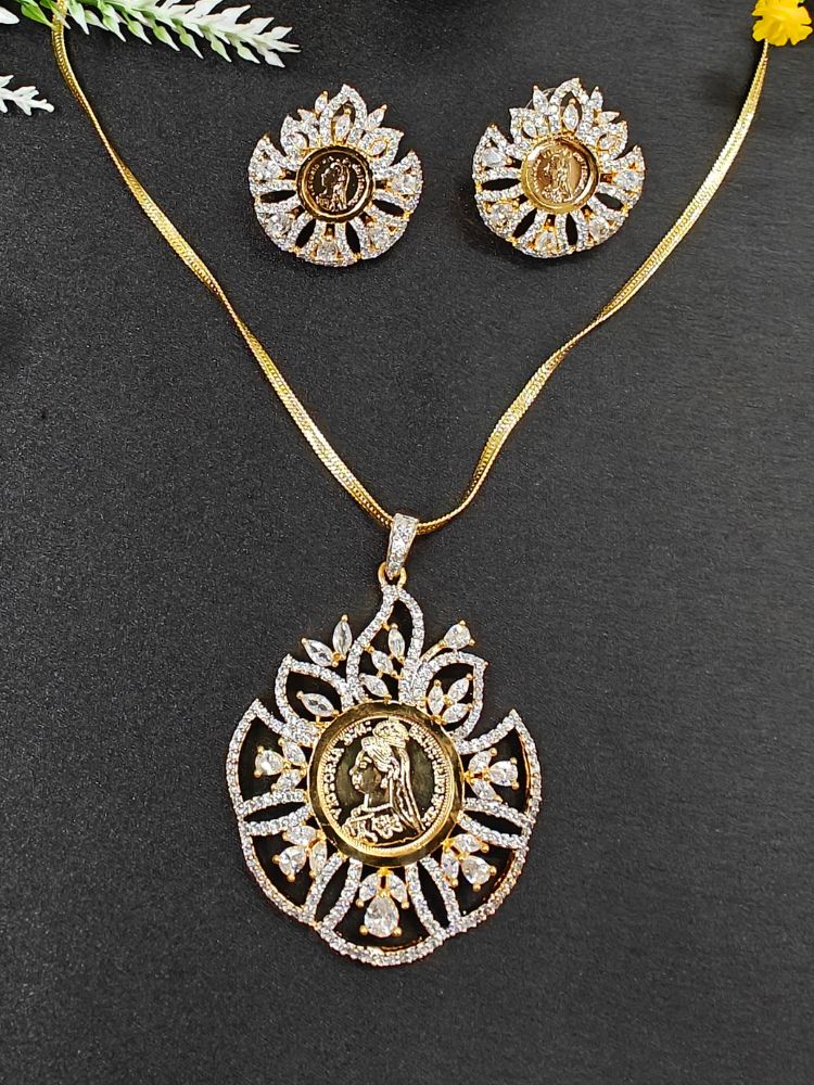 The Cleopatra Ginni Pendant Set features intricate floral designs, American Diamonds, and religious motifs at the center. Ideal for wedding ceremonies, it is displayed on a black surface with decorative leaves in the corner.