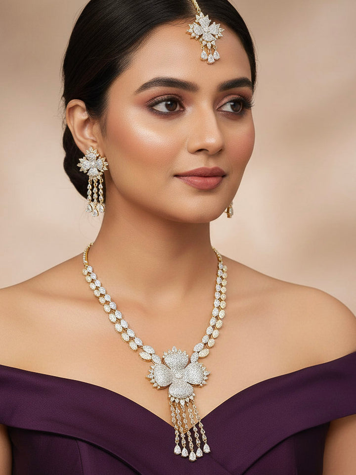 "A stunning woman wearing a glamorous artificial diamond necklace paired with chic earrings and maangtikka, perfect for bridal wear. This high-quality artificial diamond jewelry set is the ideal choice for modern brides looking for a budget-friendly option with timeless sparkle."
