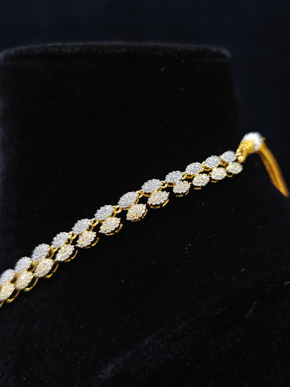A glamorous artificial diamond necklace paired with chic earrings and maangtikka, perfect for bridal wear. This high-quality artificial diamond jewelry set. Close-up of a cocktail party look featuring a premium American diamond necklace.