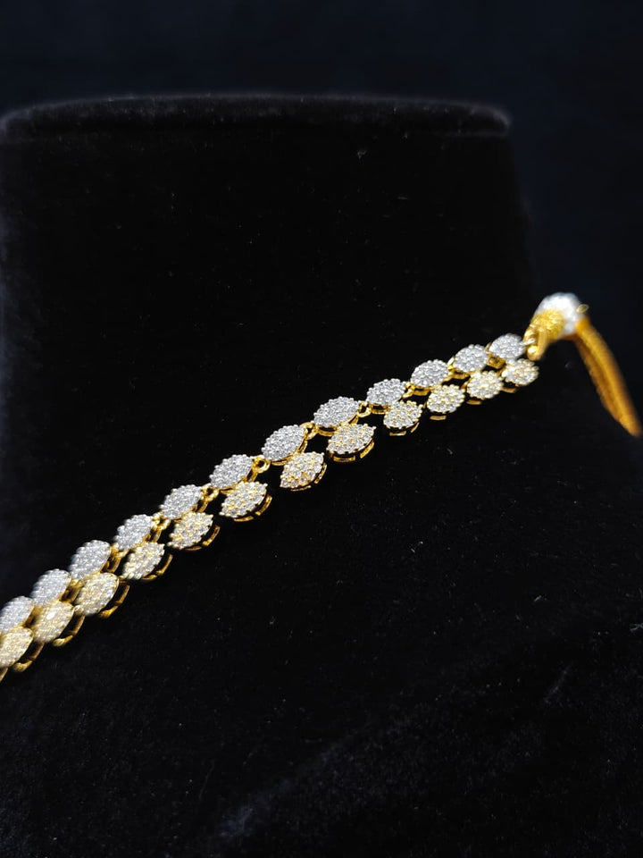 A glamorous artificial diamond necklace paired with chic earrings and maangtikka, perfect for bridal wear. This high-quality artificial diamond jewelry set. Close-up of a cocktail party look featuring a premium American diamond necklace.