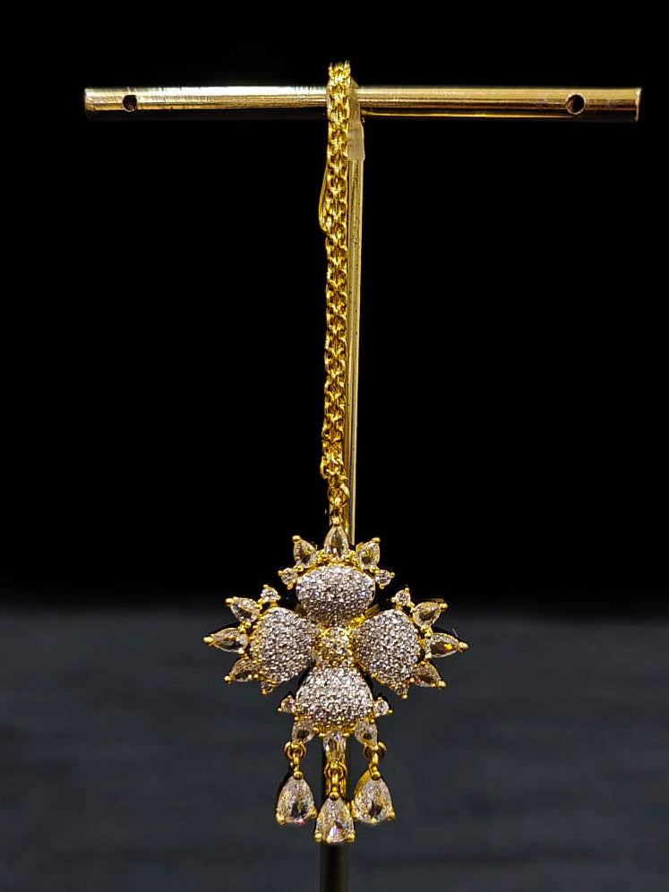 A glamorous artificial diamond necklace paired with chic earrings and maangtikka, perfect for bridal wear. This high-quality artificial diamond jewelry set. Close-up of a cocktail party look featuring a premium American diamond necklace.
