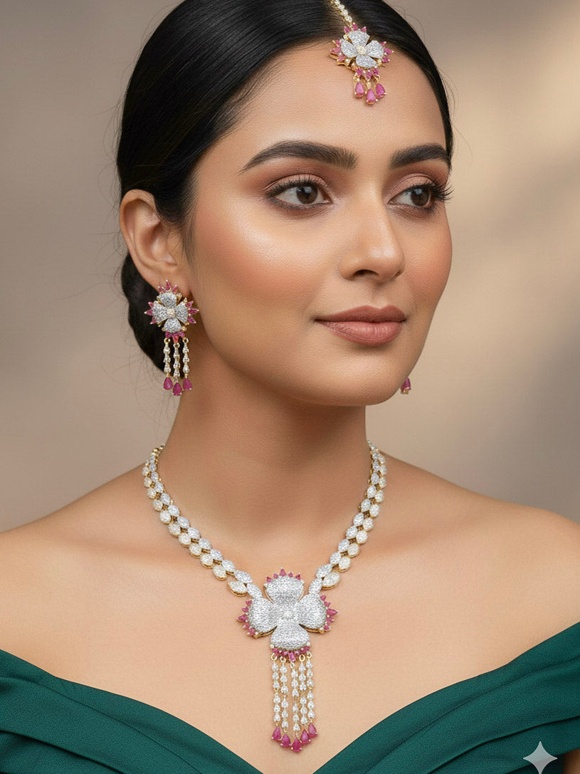 "A bride-to-be wearing an exquisite artificial diamond necklace with pink colored stone and matching earrings and maangtikka, designed for the perfect engagement look. This stunning artificial diamond jewelry set offers luxury and sophistication while being an affordable alternative to natural diamonds."