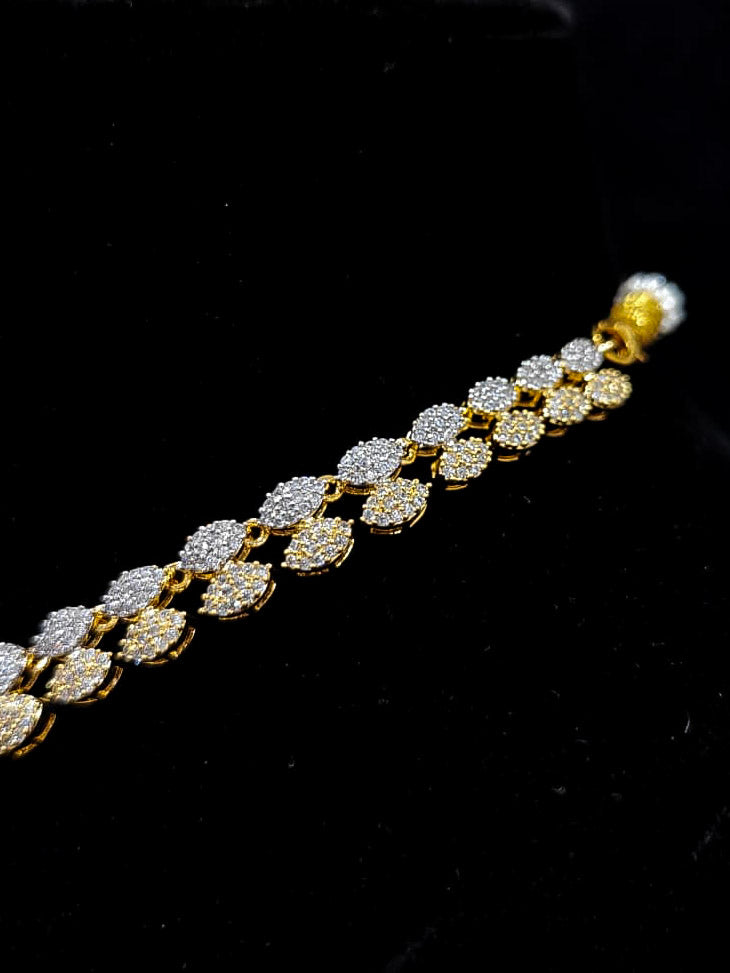 An exquisite artificial diamond necklace with pink colored stone and matching earrings and maangtikka, designed for the perfect engagement look. This stunning artificial diamond jewelry set offers luxury and sophistication while being an affordable alternative to natural diamonds.