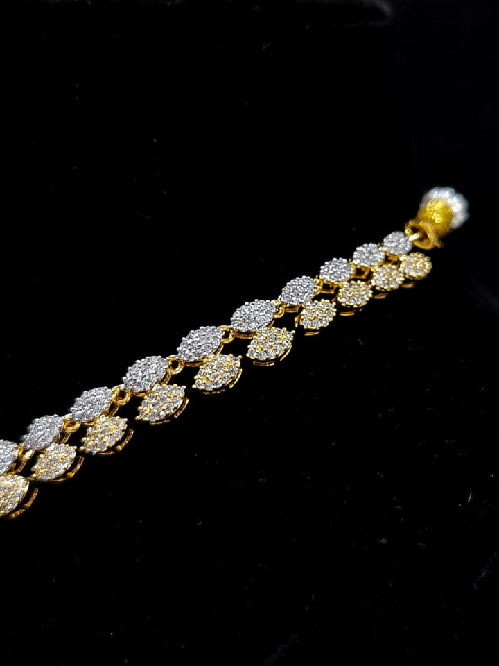 An exquisite artificial diamond necklace with pink colored stone and matching earrings and maangtikka, designed for the perfect engagement look. This stunning artificial diamond jewelry set offers luxury and sophistication while being an affordable alternative to natural diamonds.