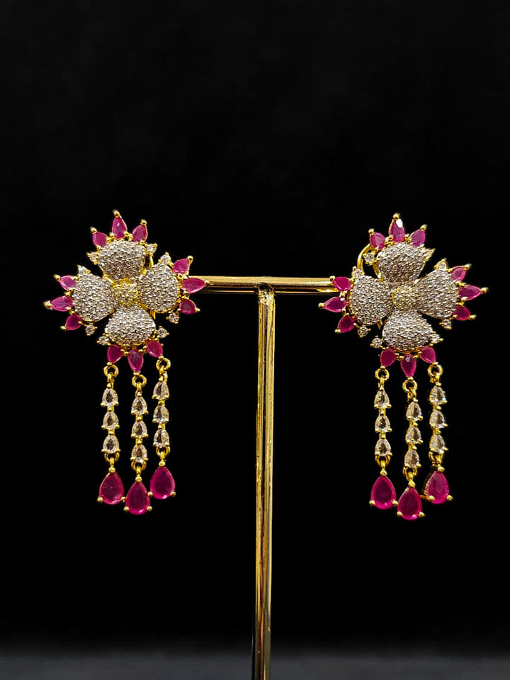 An exquisite artificial diamond necklace with pink colored stone and matching earrings and maangtikka, designed for the perfect engagement look. This stunning artificial diamond jewelry set offers luxury and sophistication while being an affordable alternative to natural diamonds.