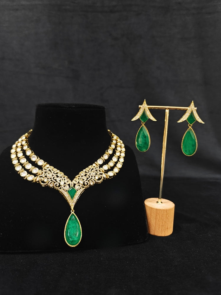 A glamorous artificial diamond and green colored stone and kudan polki necklace paired with chic earrings, perfect for bridal wear. This high-quality artificial diamond jewelry set is the ideal choice for modern brides looking for a budget-friendly option with timeless sparkle."