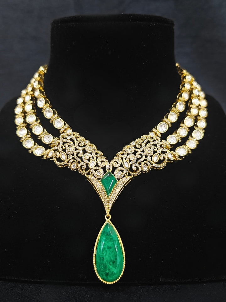A glamorous artificial diamond and green colored stone and kudan polki necklace paired with chic earrings, perfect for bridal wear. This high-quality artificial diamond jewelry set is the ideal choice for modern brides looking for a budget-friendly option with timeless sparkle."