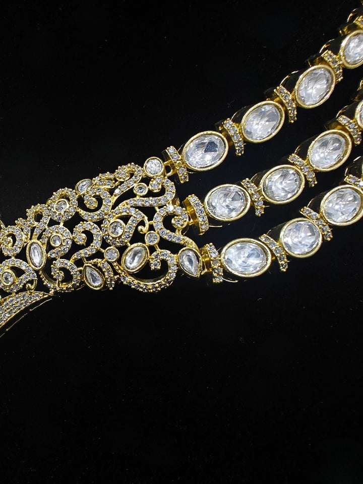 A glamorous artificial diamond and green colored stone and kudan polki necklace paired with chic earrings, perfect for bridal wear. This high-quality artificial diamond jewelry set is the ideal choice for modern brides looking for a budget-friendly option with timeless sparkle."