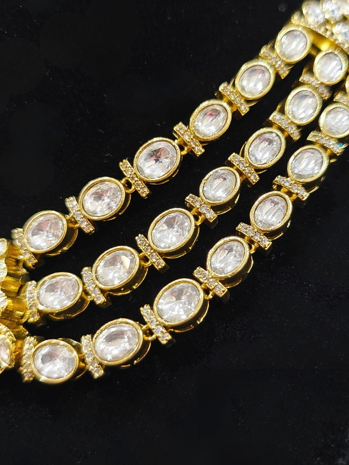An exquisite artificial diamond and red colored stone and kundan polki necklace and matching earrings, designed for the perfect engagement look. This stunning artificial diamond jewelry set offers luxury and sophistication while being an affordable alternative to natural diamonds."
