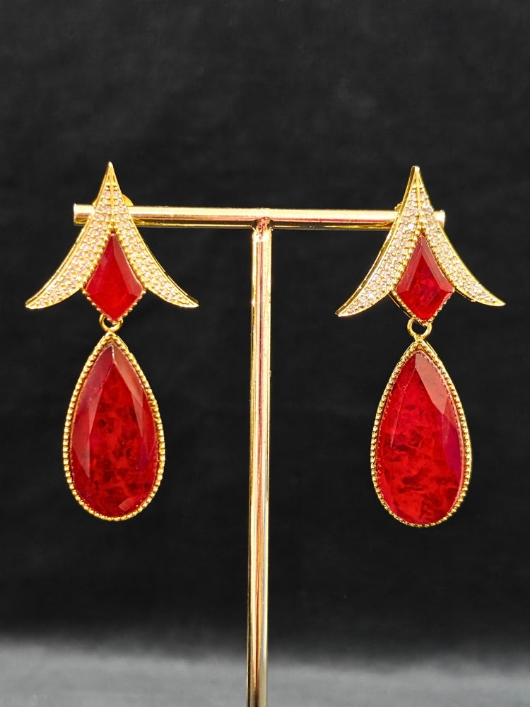 An exquisite artificial diamond and red colored stone and kundan polki necklace and matching earrings, designed for the perfect engagement look. This stunning artificial diamond jewelry set offers luxury and sophistication while being an affordable alternative to natural diamonds."