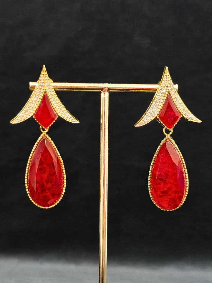 An exquisite artificial diamond and red colored stone and kundan polki necklace and matching earrings, designed for the perfect engagement look. This stunning artificial diamond jewelry set offers luxury and sophistication while being an affordable alternative to natural diamonds."