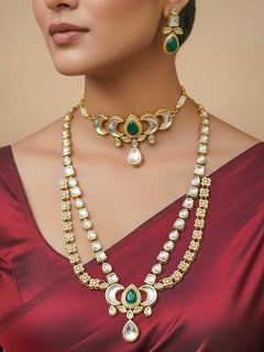Close-up of a woman wearing an ornate traditional (Gold Polish) Dark Green Long Kundan jewellery set and earrings and a Choker and Mangtikka with Kundan and Colored Stones. Wedding celebration look enhanced with a statement Kundan necklace. Bride wearing a royal Kundan artificial necklace for wedding rituals.