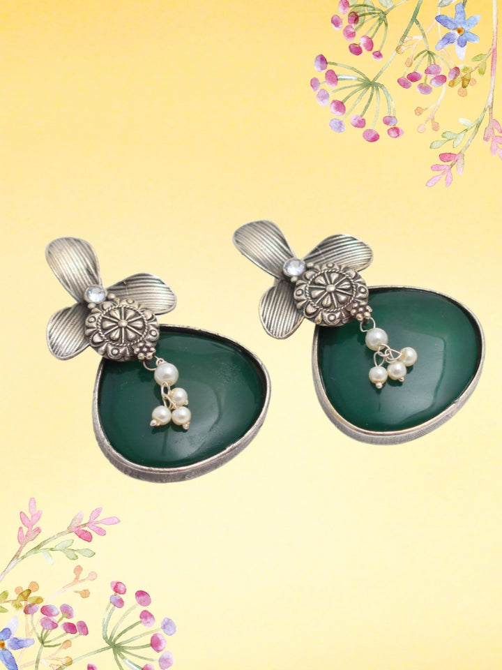 David Dark Green oxidized Earrings feature silver flower-shaped tops, decorative floral details, and Dark Green teardrop stones. Small white pearls dangle at the center, adding a touch of elegance to these stylish german silver earrings.  Oxidized earrings from the oxidized jewelry collection. 