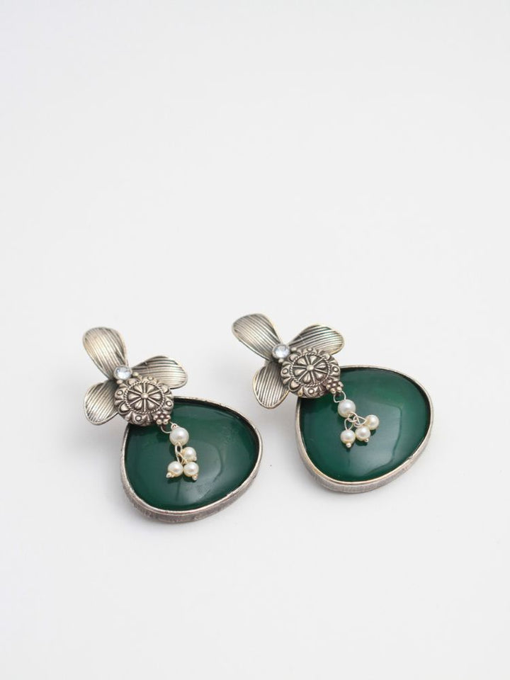 David Dark Green oxidized Earrings feature silver flower-shaped tops, decorative floral details, and Dark Green teardrop stones. Small white pearls dangle at the center, adding a touch of elegance to these stylish german silver earrings.  Oxidized earrings from the oxidized jewelry collection. 