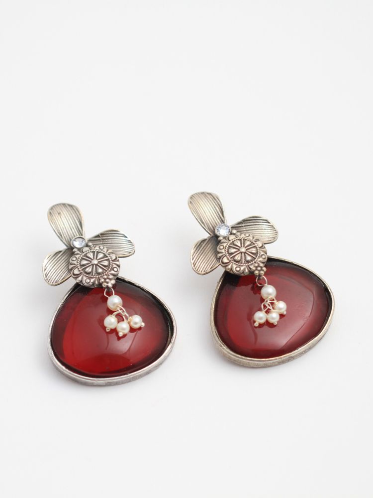 David Maroon oxidized Earrings feature silver flower-shaped tops, decorative floral details, and Maroon teardrop stones. Small white pearls dangle at the center, adding a touch of elegance to these stylish german silver earrings.  Oxidized earrings from the oxidized jewelry collection. 