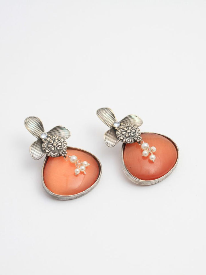 David Orange oxidized Earrings feature silver flower-shaped tops, decorative floral details, and Orange teardrop stones. Small white pearls dangle at the center, adding a touch of elegance to these stylish german silver earrings.  Oxidized earrings from the oxidized jewelry collection. 