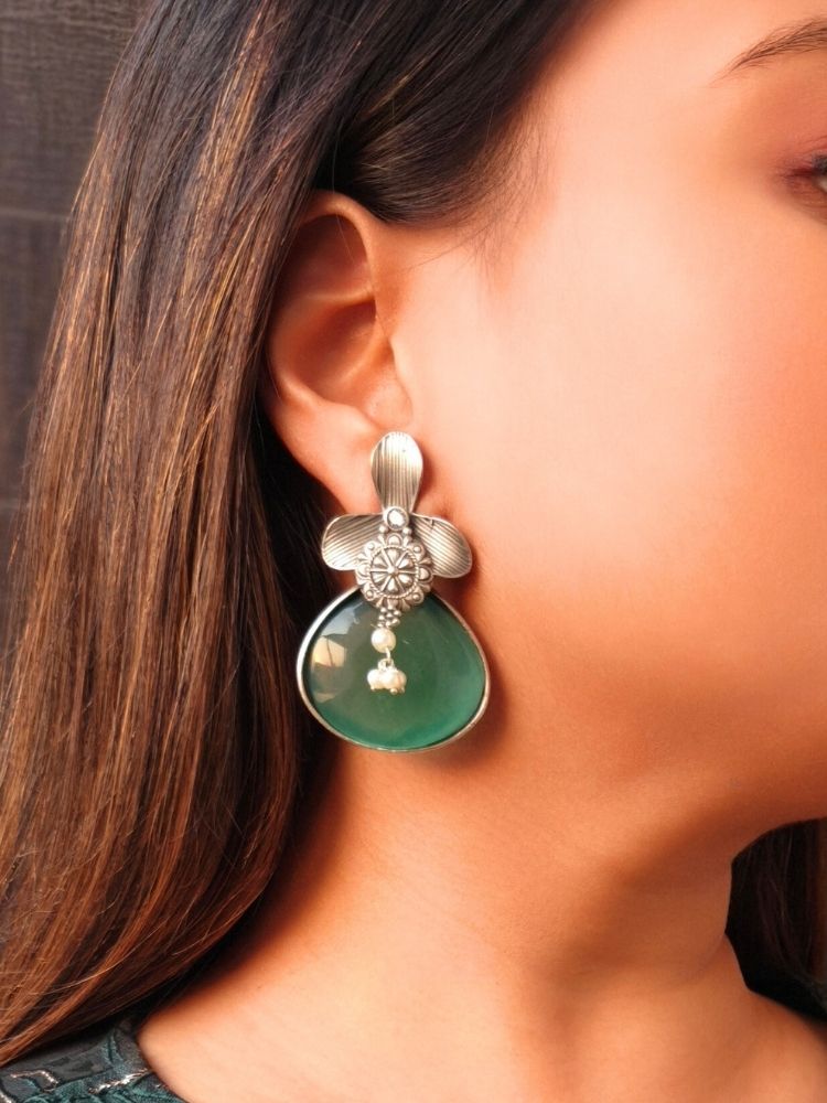 David Sea-green oxidized Earrings feature silver flower-shaped tops, decorative floral details, and sea -green eardrop stones. Small white pearls dangle at the center, adding a touch of elegance to these stylish german silver earrings.  Oxidized earrings from the oxidized jewelry collection. 