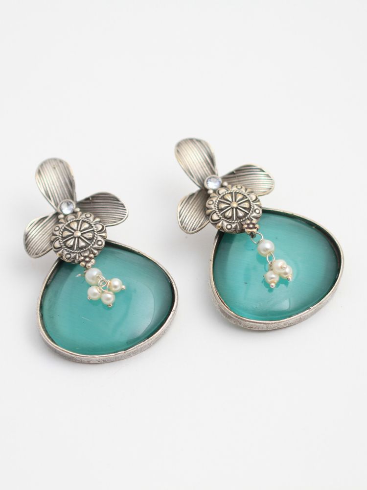 David Sea Green oxidized Earrings feature silver flower-shaped tops, decorative floral details, and Sea Green teardrop stones. Small white pearls dangle at the center, adding a touch of elegance to these stylish german silver earrings.  Oxidized earrings from the oxidized jewelry collection. 