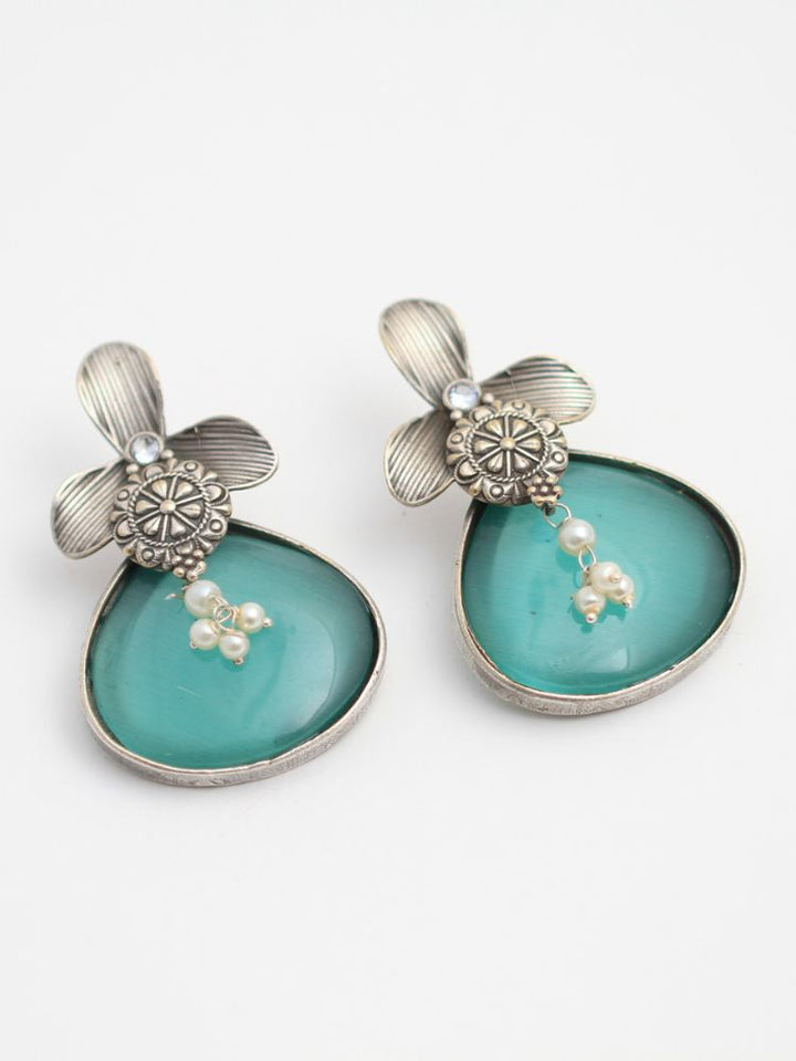 David Sea Green oxidized Earrings feature silver flower-shaped tops, decorative floral details, and Sea Green teardrop stones. Small white pearls dangle at the center, adding a touch of elegance to these stylish german silver earrings.  Oxidized earrings from the oxidized jewelry collection. 